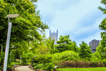 Pittsburgh skyline view framed by lush greenery in springtime park