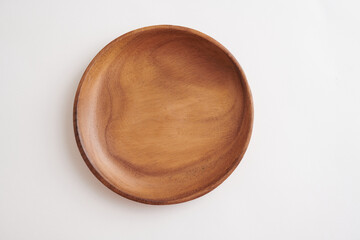 Round Wooden Plate with Smooth Finish on White Background. Top view