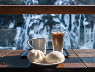 White coffee mug and breakfast with snow background in winter.