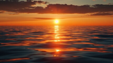 Fototapeta premium Sunset over the ocean creating a vibrant and colorful sky with waves gently crashing on the shore