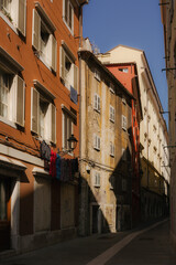Sunlit Alley with Hanging Clothes