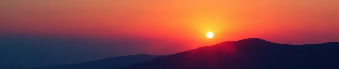 Softly glowing orange sun rises behind a hill, dawn light, sky