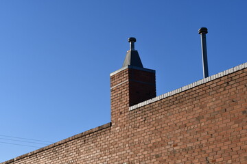 Red brick building with modern chimney.