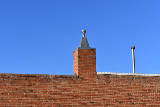 Red brick building with chimney. Modern insert in classical structure.