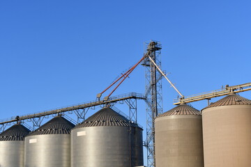 Grain silos and tower with beautiful blue background.