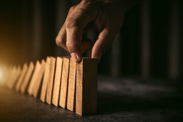 Hand place wooden block stack in pyramid stair step concept team building of prevent not collapse...