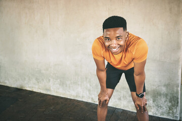 Urban, black man and portrait with tired for workout, burnout and fitness challenge for marathon runner. Wall, male person and athlete with smile for rest, exercise fatigue and break by mockup space