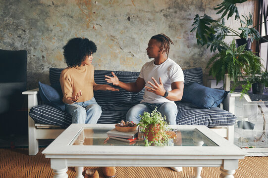 Couple, fight and argument in home for divorce, marriage fail and problem with toxic relationship in living room. African man, woman and conflict for breakup, cheating mistake and affair with drama