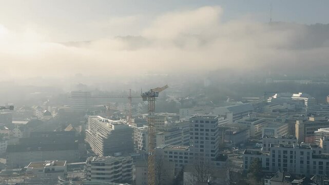 Aerial view of an urban construction site, towering cranes mov, working on a infrastructural project