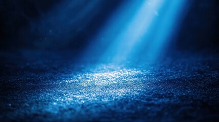 Blue light beam on textured surface, dark background, product display