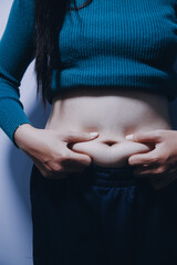 Asian Woman Pinching Her Belly Fat With Left Hand