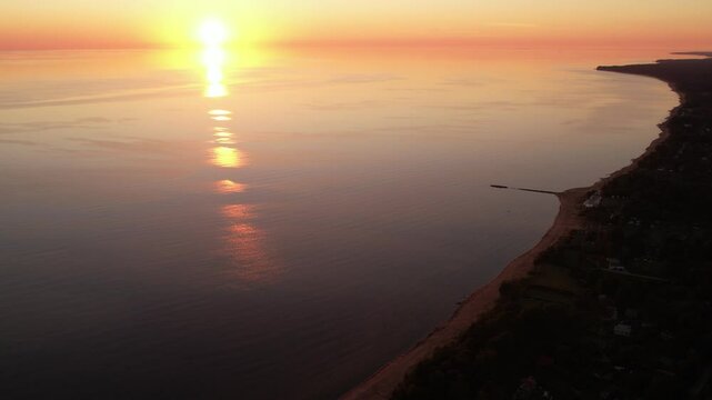 Tranquil Sunset Over a Calm Coastal Shoreline with Reflective Waters. Latvia. Tuja village