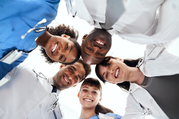 Happy, doctor or portrait with team below for meeting, huddle or healthcare community at hospital....