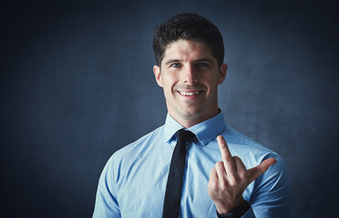 Portrait, business and man with middle finger, rude gesture and professional on dark studio...