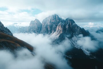 Majestic mountain range shrouded in mist, aerial view, travel poster