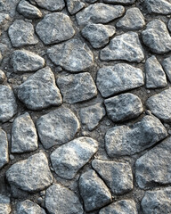 Obraz premium Tileable cobblestone road texture with irregularly shaped rocks in varying shades of gray. The realistic stone pattern creates a rugged and durable surface for design projects and 3D environments. 