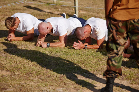 Men, fitness or army with plank for military training, physical activity or bootcamp on grass field. Male people, trainer or superior officer with team of soldiers in drill for endurance test or exam