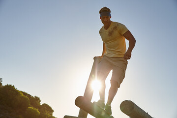 Athlete man, jumping and course of obstacle for physical strength, army training and body balance. Active, person and fitness with survival assessment, core exercise and workout challenge at bootcamp