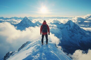 Mountaineer standing on snowy mountain peak enjoying the breathtaking view of the Alps