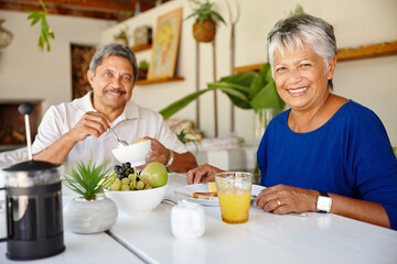 Senior couple, portrait and eating breakfast for nutrition, healthy diet and cereal for wellness in home. Retirement, man and happy woman with food, morning meal and together with partner in Mexico
