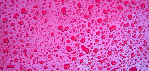 background with texture of rain drops on a red metallic surface close-up