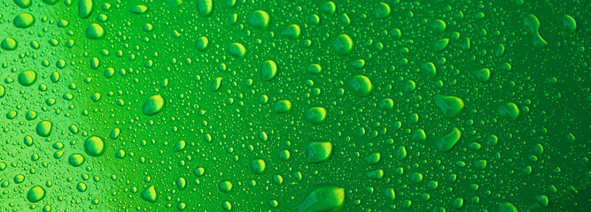 abstract green background with the texture of rain drops on a metal surface close-up