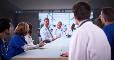 Fototapeta premium Medical professionals of various ethnicities hold video conference discussing