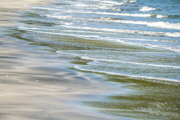 The sea water on the beach is a wave of various forms for background.