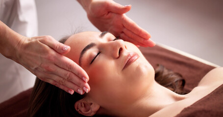 Female Physiotherapist Providing Reiki Therapy