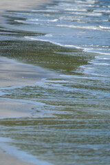 The sea water on the beach is a wave of various forms for background.