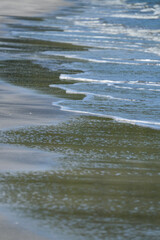 The sea water on the beach is a wave of various forms for background.