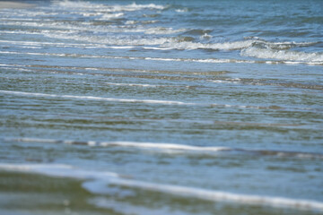 The sea water on the beach is a wave of various forms for background.