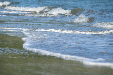 The sea water on the beach is a wave of various forms for background.