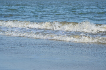 The sea water on the beach is a wave of various forms for background.