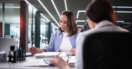 Multicultural financial advisor discussing invoices and tax compliance