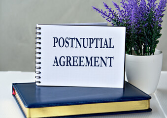 POSTNUPTIAL AGREEMENT - words in a notebook against the background of a diary and lavender
