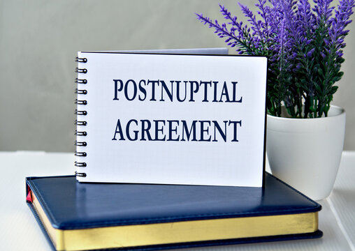 POSTNUPTIAL AGREEMENT - words in a notebook against the background of a diary and lavender