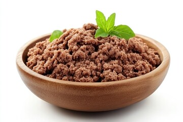 Ground meat in a wooden bowl with basil garnish