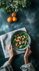 Person holding a plate of food with oranges and a vegan recipes magazine in a realistic photograph