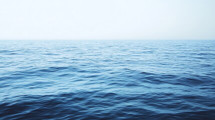 Calm ocean water under a clear and bright morning sky