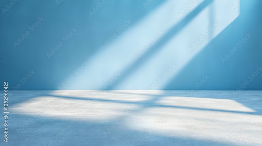 Poster sunlight streams through a window onto a light blue wall and concrete floor in an empty room, ideal 