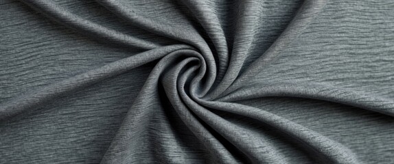 Fototapeta premium Close-up of gray textured fabric in a spiral arrangement on a dark background