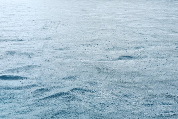 Fresh of the rain falling on the sea surface with feeling of relaxation and peace in tropical natural seasonal