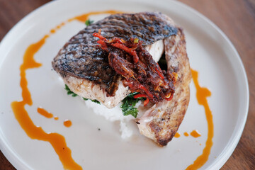 Traditional food deep fried fish Seabass with chlli sauce with rice on white dish 