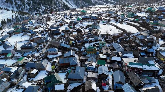 Aerial drone shot of Chitkul&rsquo;s snow-draped mountains and valleys under a clear blue sky.