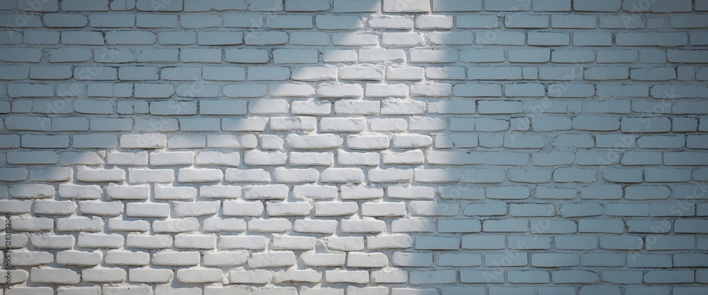 Poster white brick wall with shadows creating a textured background for design and architecture concepts