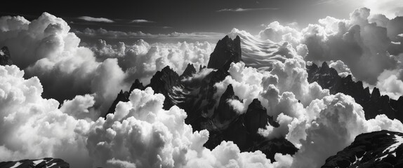 Black and white mountain landscape with dramatic cloud formations under a moody sky