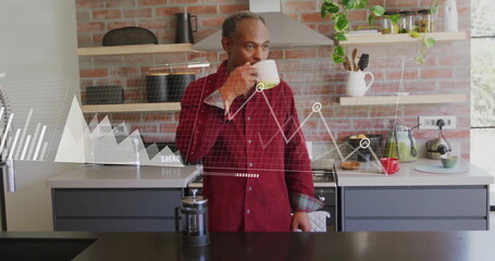 Image of data processing over senior african american man drinking coffee in kitchen