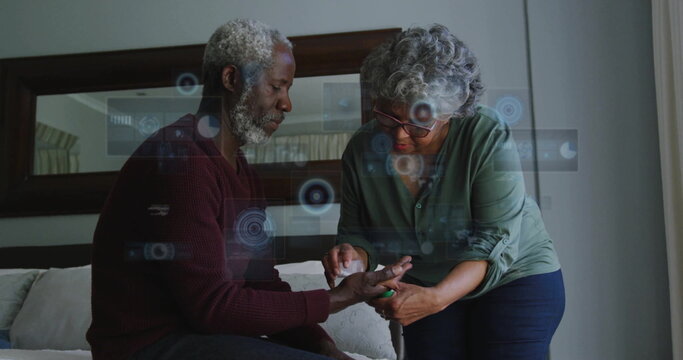 Image of data processing over senior african american couple cleaning hand