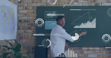 Image of diagrams and data processing over caucasian male teacher writing on board